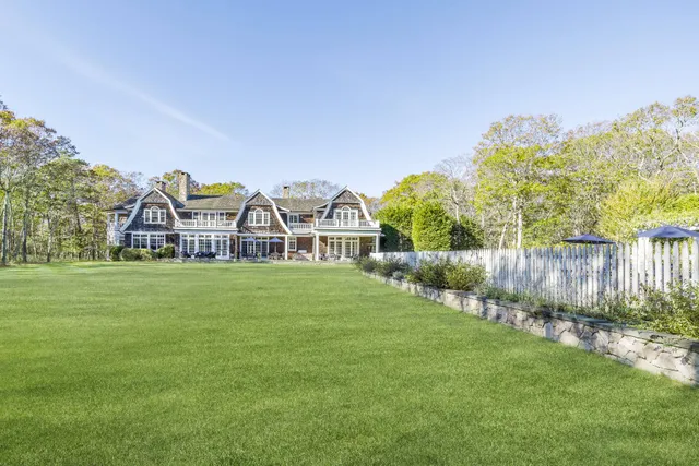 a view of a house with garden and a trees