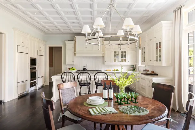 a view of a dining room with furniture a chandelier and wooden floor