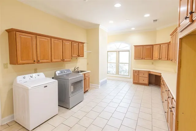 a kitchen with a stove sink and cabinets
