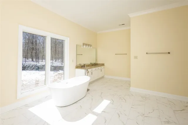 a spacious bathroom with a bathtub and a sink