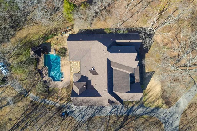an aerial view of a house with a yard