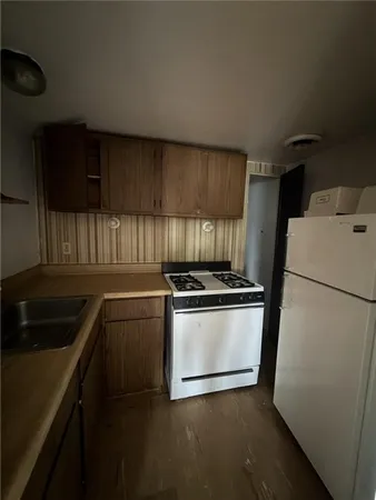 a kitchen with a stove microwave and sink
