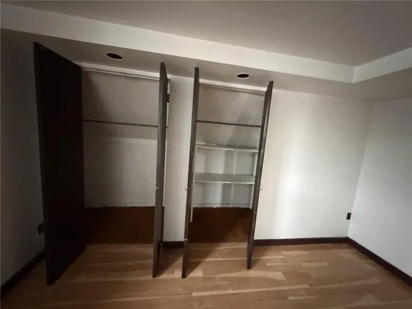 a view of walk in closet with empty racks