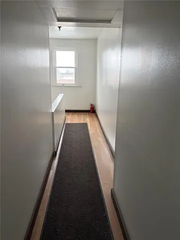 a view of hallway with wooden floor