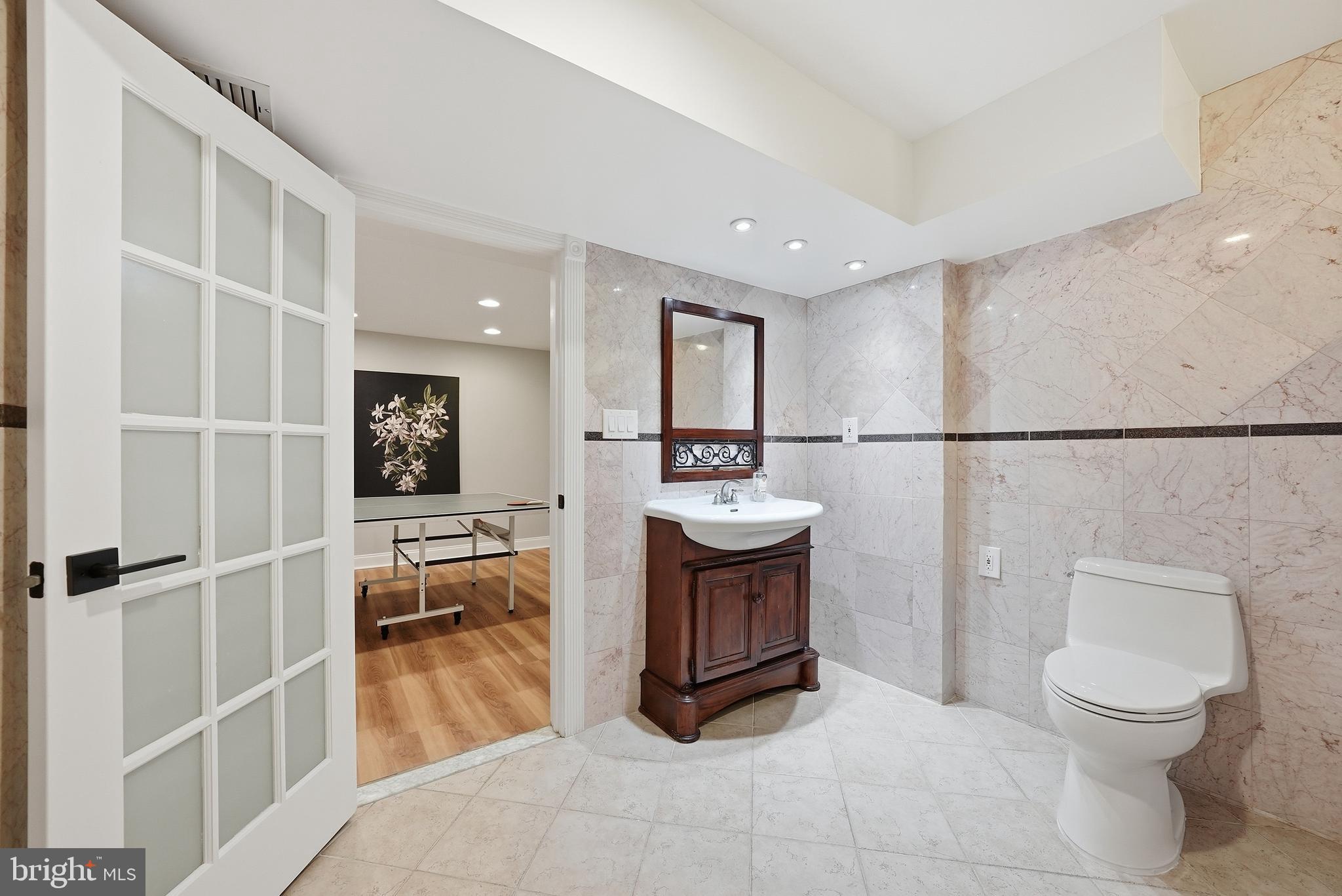 1291 Lamplighter Way Reston, VA 20194 - Photo 53 of 60 a spacious bathroom with a toilet a sink a mirror and a shower