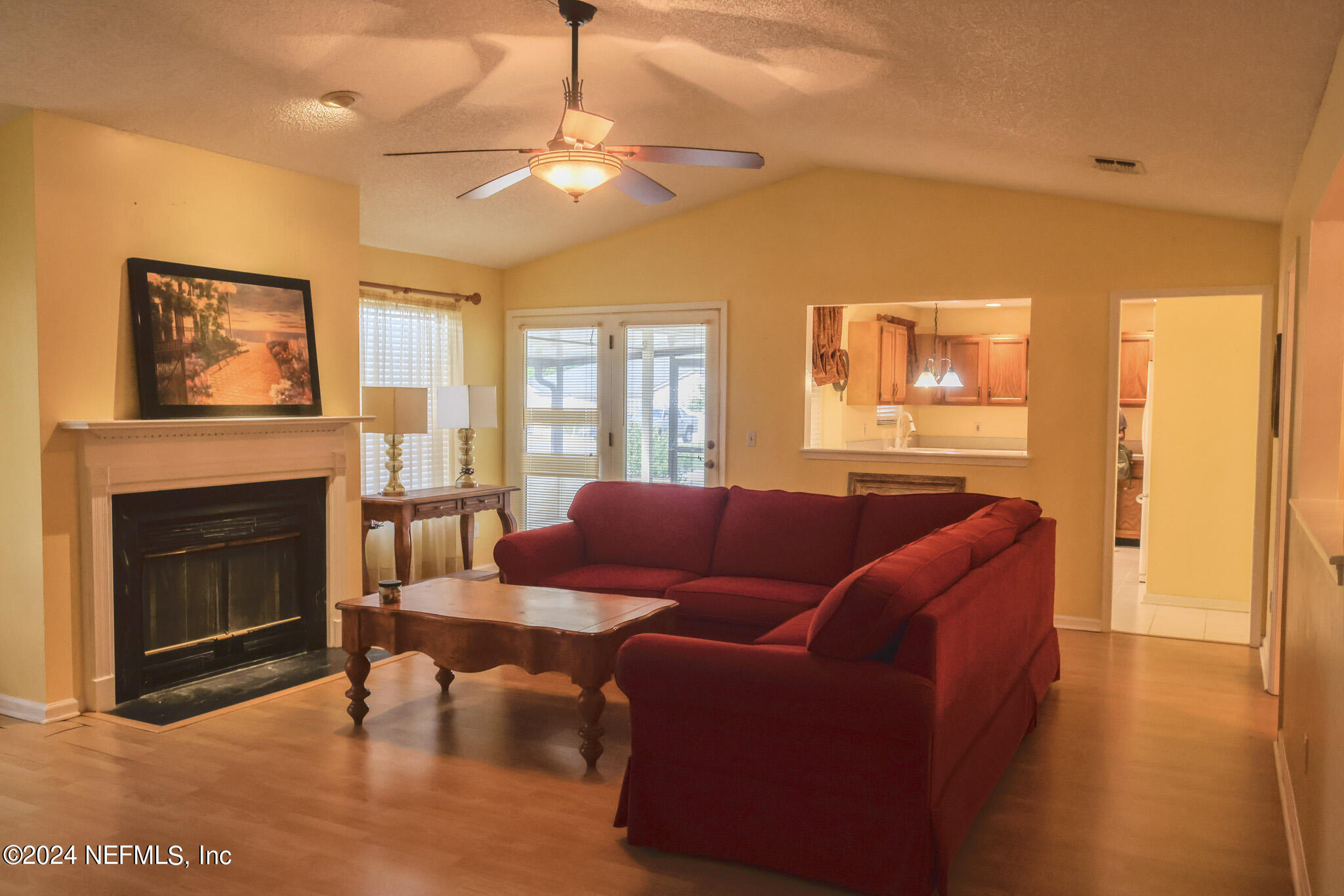 1662 Rusty Rail Road Jacksonville, FL 32225 - Photo 14 of 27 a living room with furniture a flat screen tv and a fireplace
