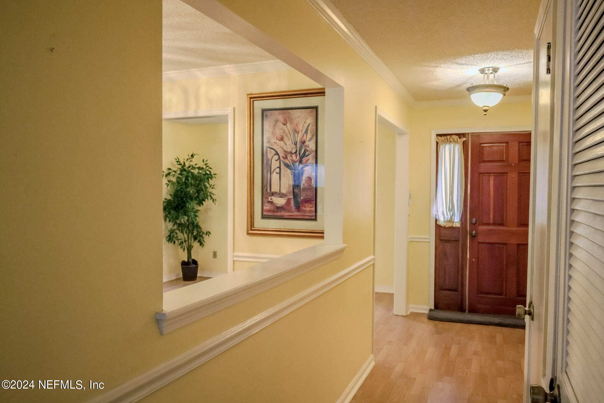 1662 Rusty Rail Road Jacksonville, FL 32225 - Photo 23 of 27 a view of a hallway with paintings on the wall