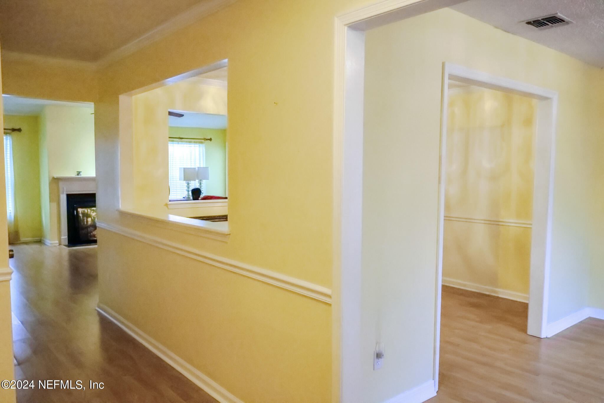 1662 Rusty Rail Road Jacksonville, FL 32225 - Photo 8 of 27 a view of a hallway with wooden floor and a bathroom