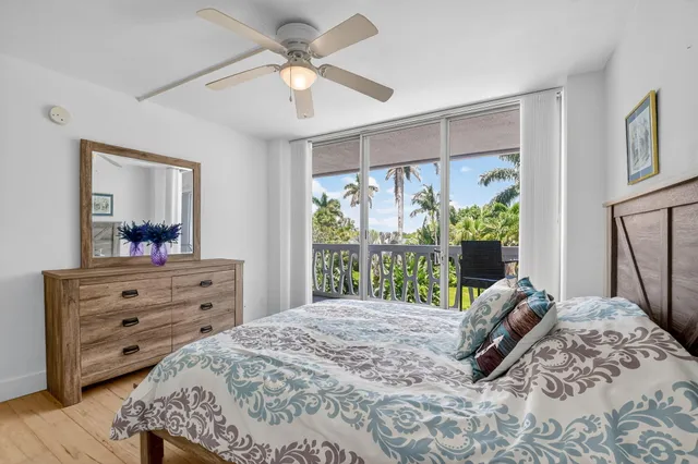 a bedroom with a bed window and a flat screen tv