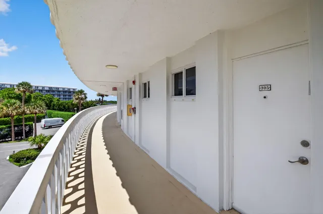 a view of a balcony with wooden floor and stairs
