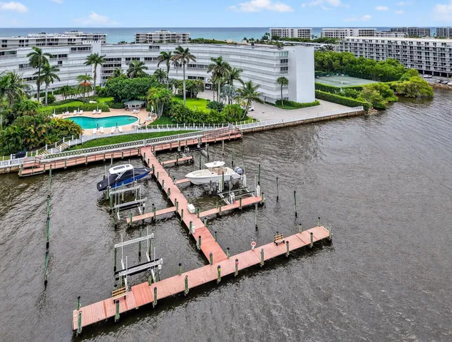 an aerial view of a house with a garden and lake view