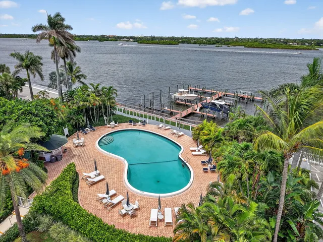 an aerial view of a house with a lake and a mountain view