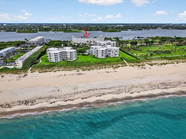 an aerial view of a house with a garden and lake view