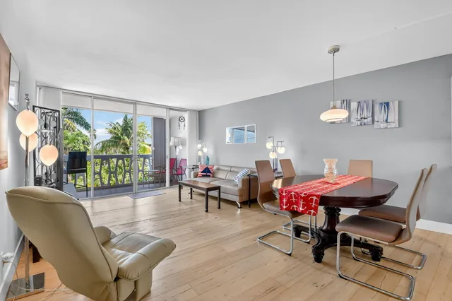 a living room with furniture a window and a flat screen tv