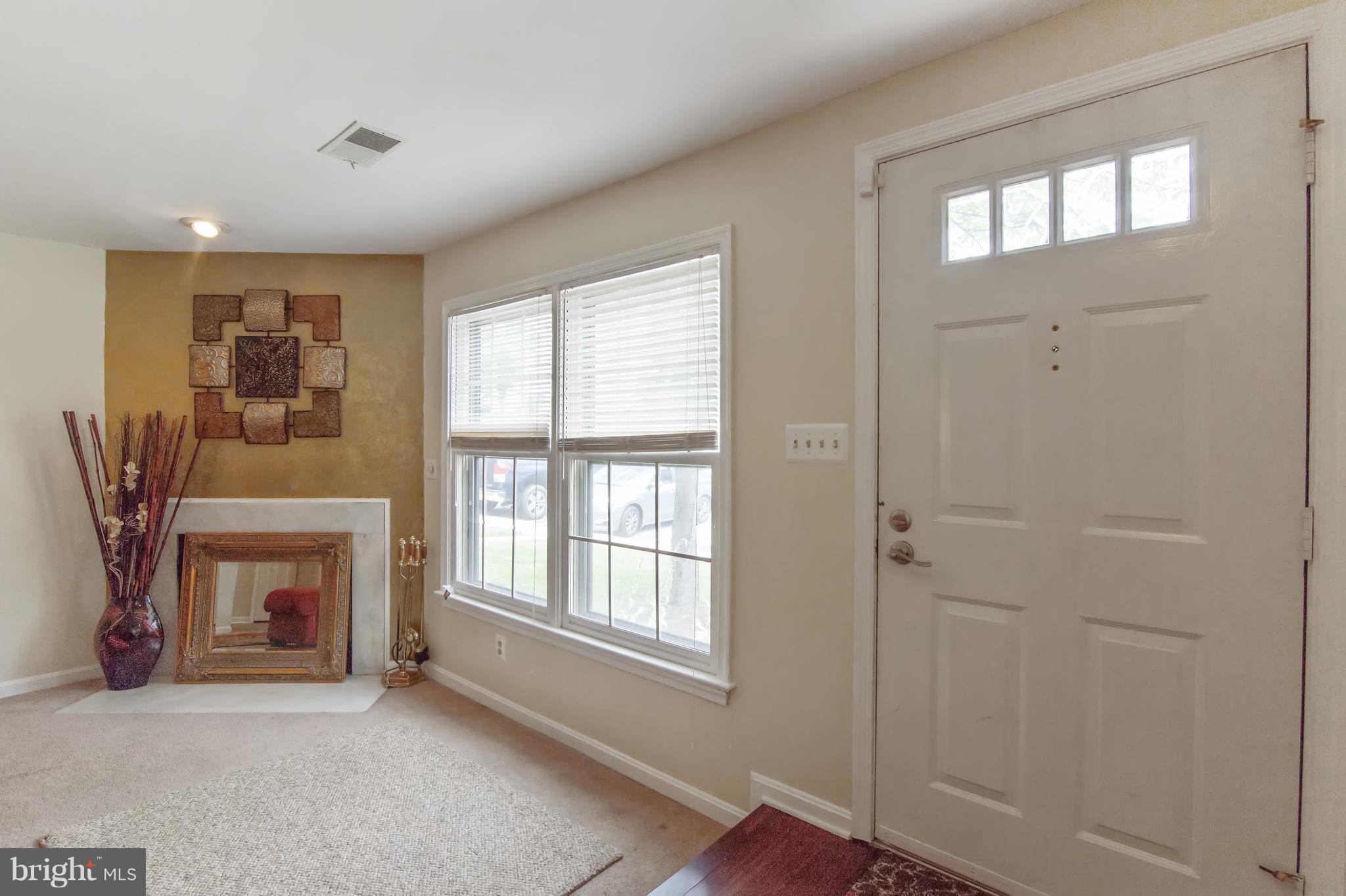 9304 Palmer Place, Unit 5 Laurel, MD 20708 - Photo 5 of 30 a view of an empty room with a window and fireplace
