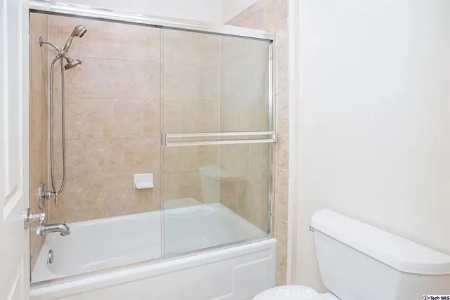 a bathroom with a toilet and a bathtub