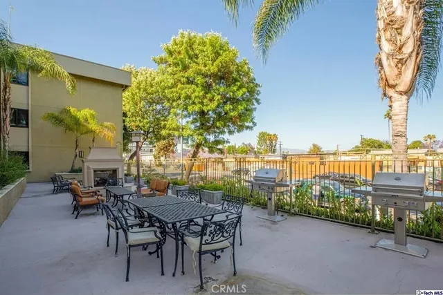 a view of a patio with table and chairs and potted plants