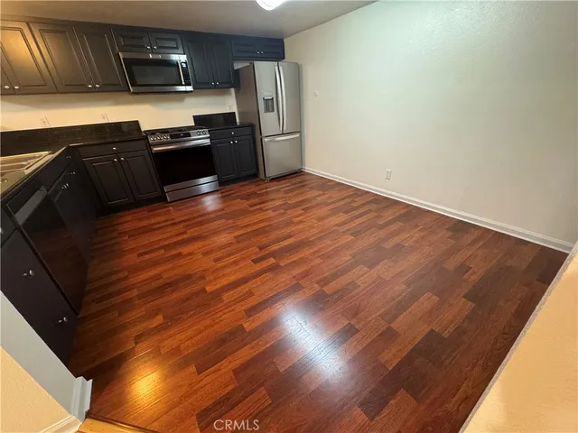 a kitchen with granite countertop stainless steel appliances and wooden cabinets