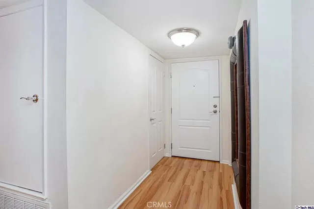 a view of a hallway with wooden floor