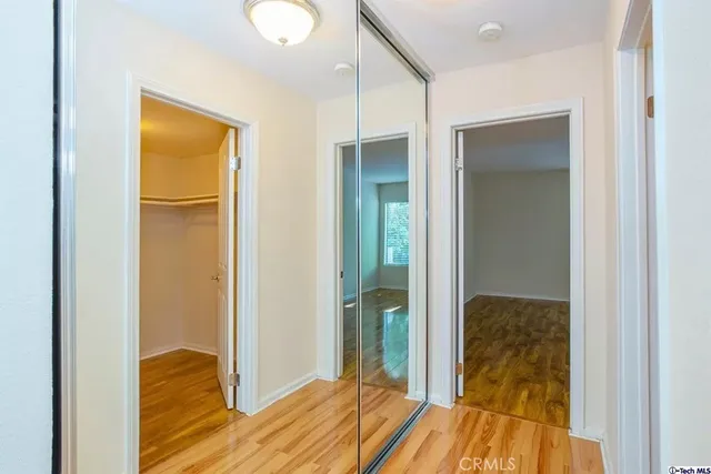 a view of bedroom with bathroom and wooden floor