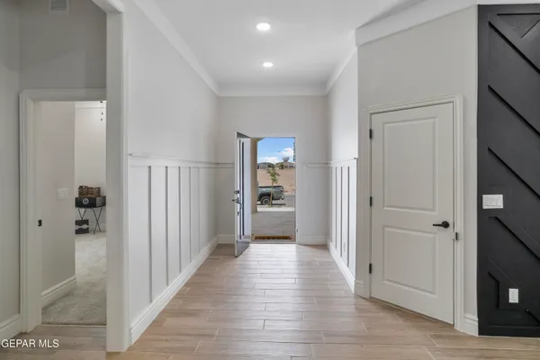a view of a hallway with wooden floor