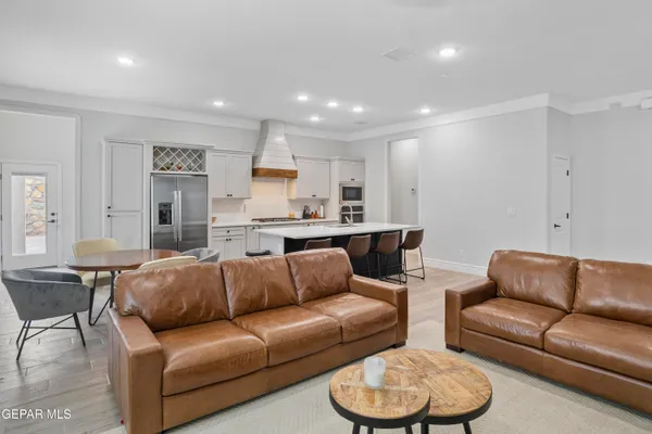 a living room with furniture and a view of kitchen