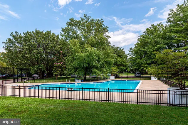 a view of a tall building next to a yard