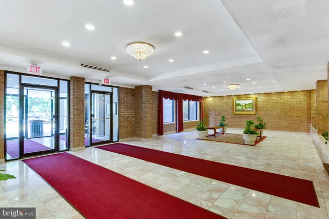 a room with pool table and large windows