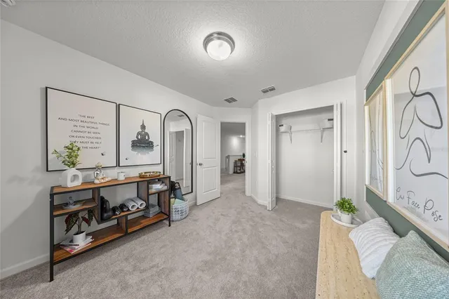 a spacious bedroom with a bed and a dresser in it