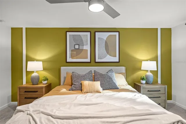 a bedroom with a bed and lamp