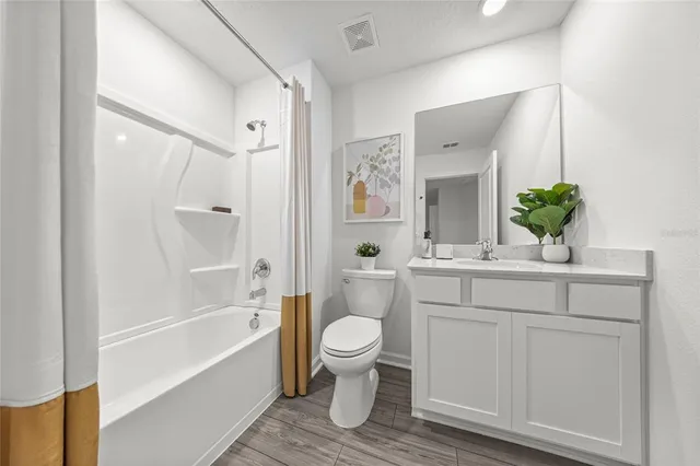 a bathroom with a sink a mirror a toilet and a bathtub