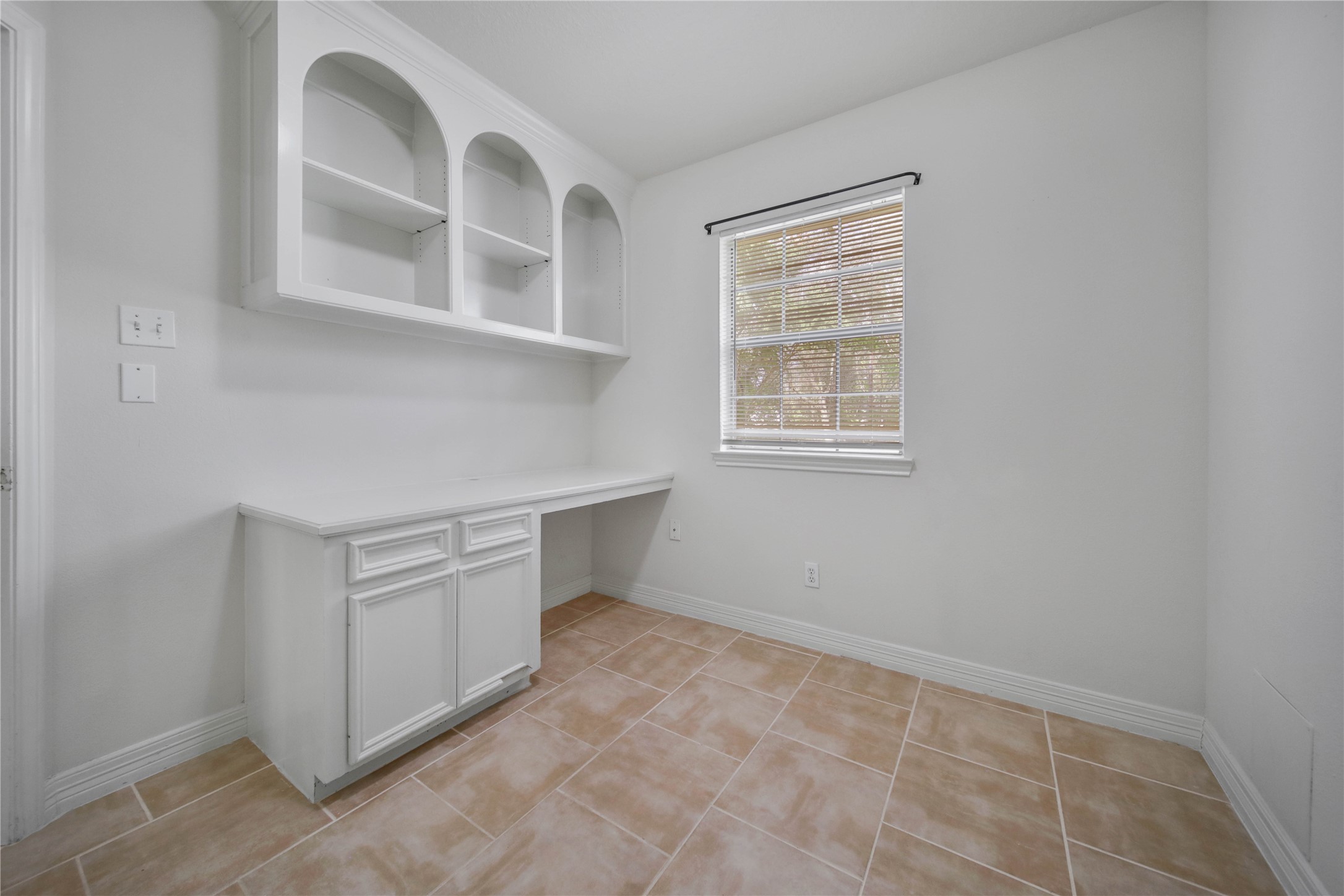 4943 Gammage Street Houston, TX 77021 - Photo 12 of 22 The study offers a built-in desk and storage, ideal for anyone who works from home or wants a private retreat to study in. It could also serve as a hobby room, workout room or fourth bedroom.