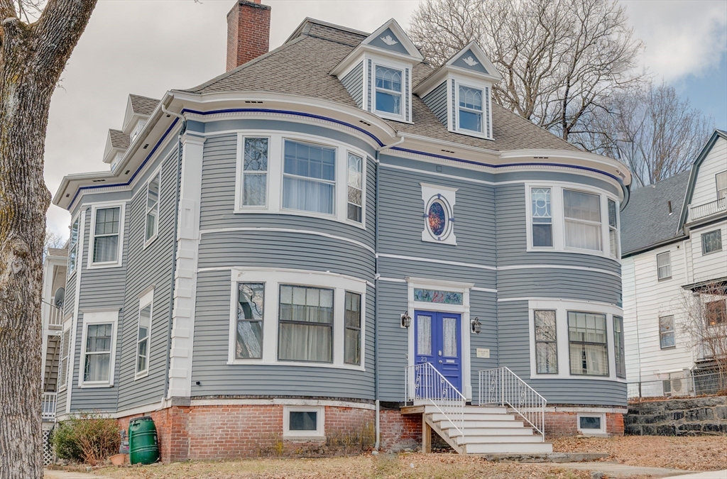 a front view of a building with a yard