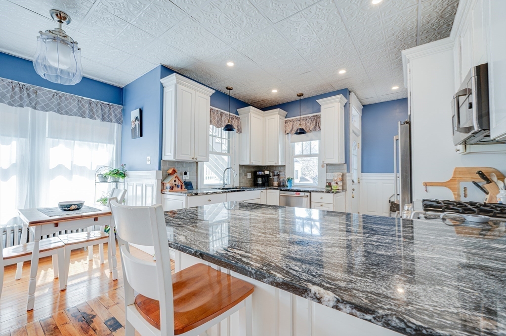 23 Germain Street Worcester, MA 01602 - Photo 13 of 42 a view of a kitchen with kitchen island stainless steel appliances and a counter top space