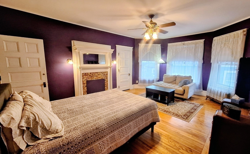 23 Germain Street Worcester, MA 01602 - Photo 18 of 42 a bedroom with a bed and a chandelier