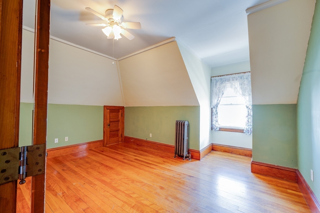 23 Germain Street Worcester, MA 01602 - Photo 32 of 42 a bedroom with a bed and a chandelier