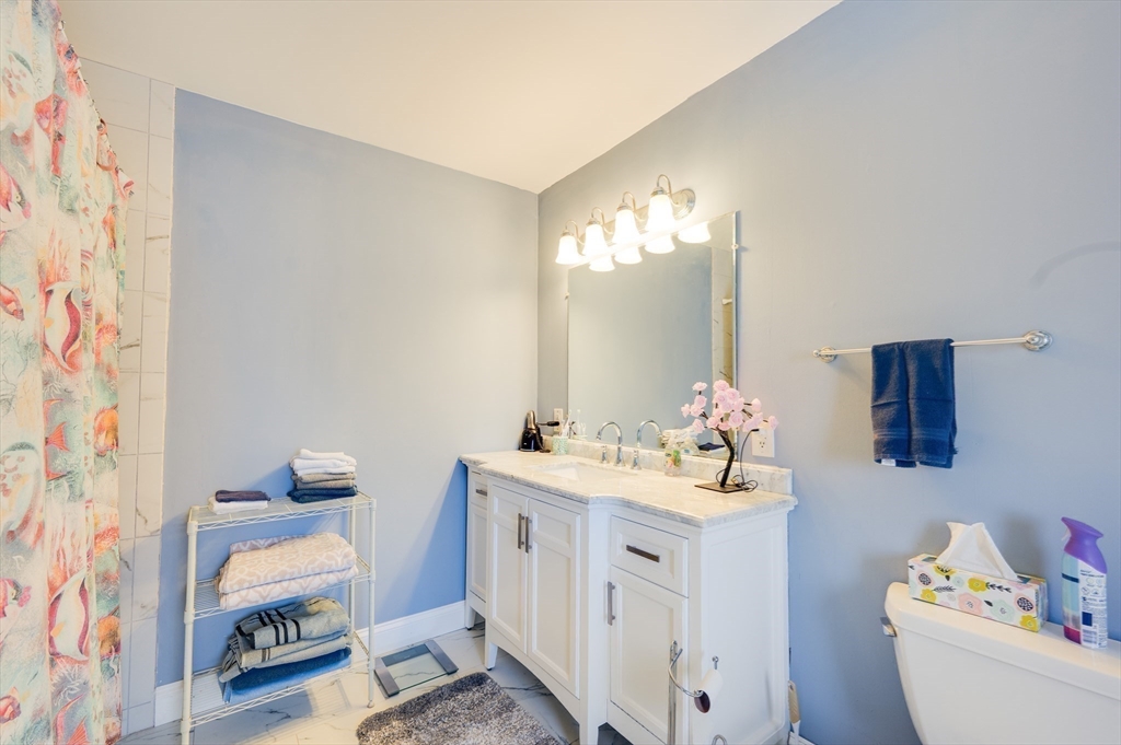 23 Germain Street Worcester, MA 01602 - Photo 34 of 42 a bathroom with a sink vanity mirror and toilet