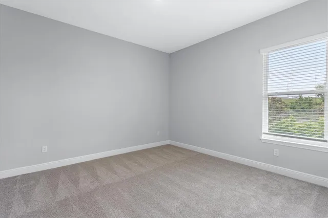 a view of an empty room and closet area