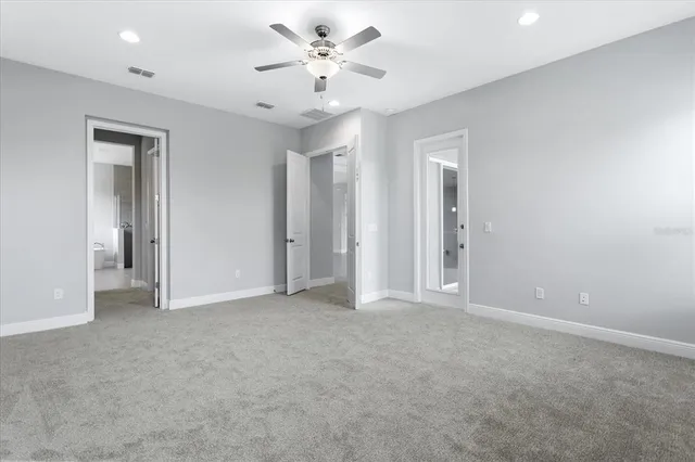 a bathroom with a granite countertop sink a toilet a mirror and bathtub