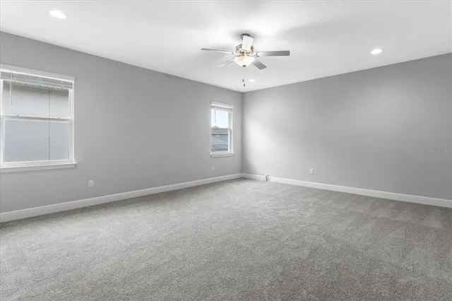an empty room with fan and ceiling fan