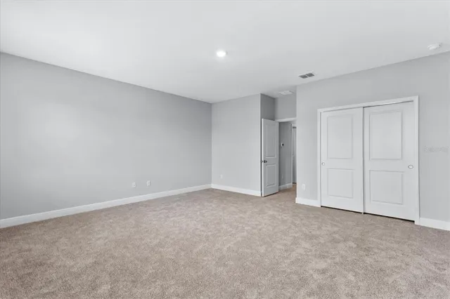 a view of a closet area with ceiling fan