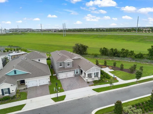 an aerial view of a house with a garden and lake view