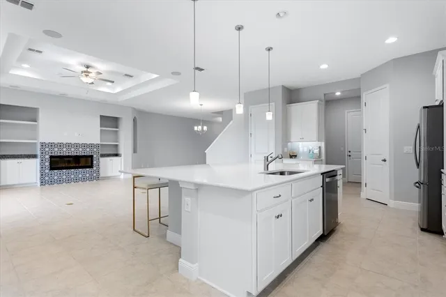 a kitchen with appliances a sink and a refrigerator