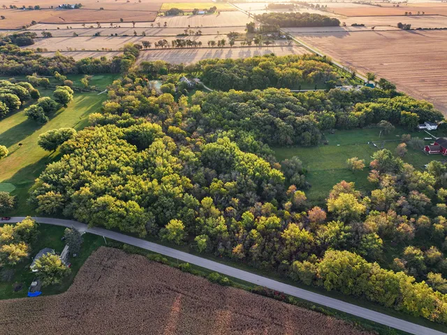 an aerial view of a house with a yard and lake view
