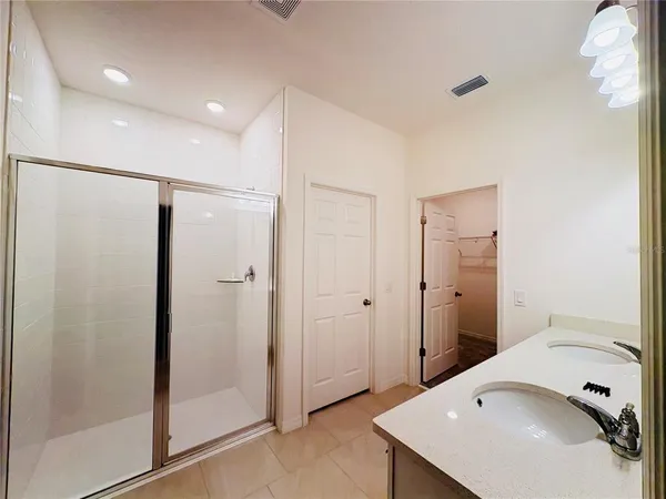 a bathroom with a sink and shower