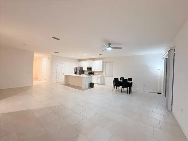 a view of kitchen with furniture and refrigerator