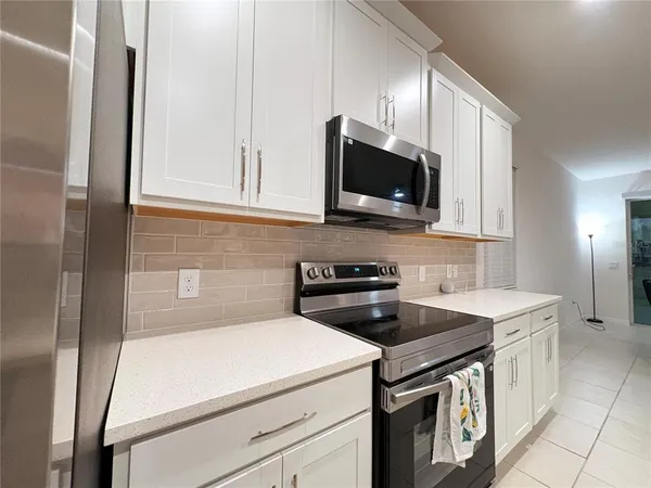 a kitchen with a sink and a stove top oven