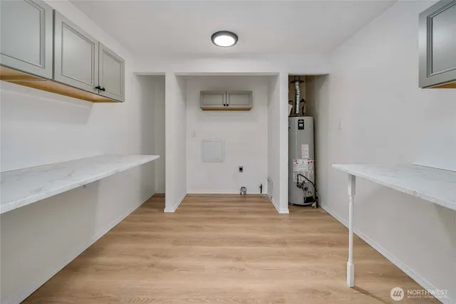 a view of empty room with cabinet and fan