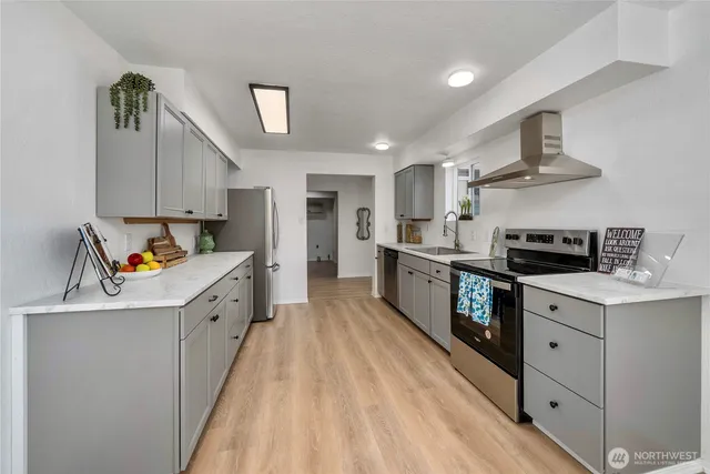 a kitchen with granite countertop a sink and a stove top oven
