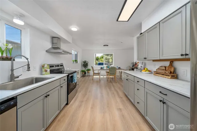 a kitchen with cabinets a sink and wooden floor